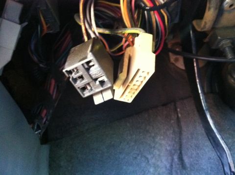 1989 Ford Mustang - Close-up view of electrical connectors and wiring within a vehicle's interior.