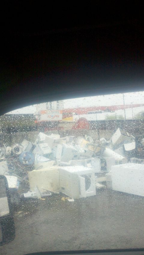 1988 Ford Bronco - Discarded appliances piled up at a junkyard, likely awaiting recycling or disposal.