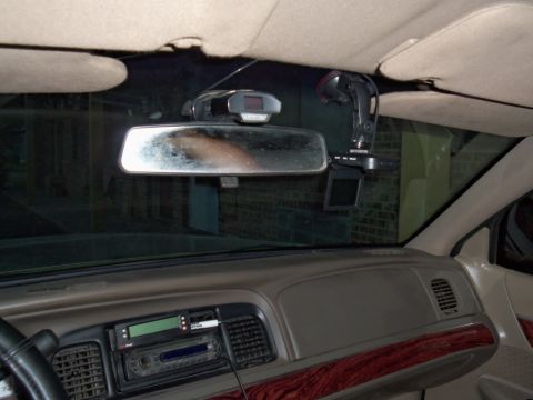 2000 Mercury Grand Marquis - Interior view of a 2000 Mercury Grand Marquis dashboard, showing aftermarket electronics mounted near the rearview mirror.