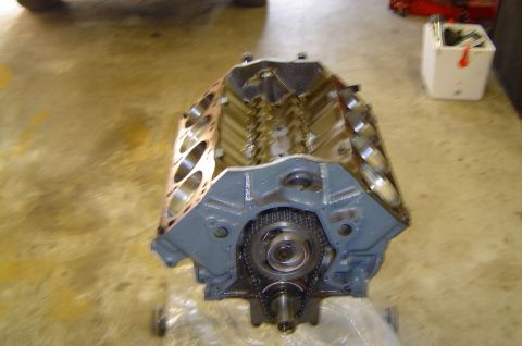 1993 Ford Bronco - An engine block is shown with its timing chain and gears exposed, likely awaiting assembly or repair.