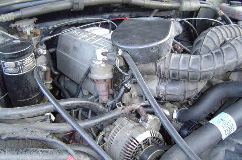 1993 Ford Bronco - Close-up view of the engine compartment of a 1993 Ford Bronco, detailing various engine components.