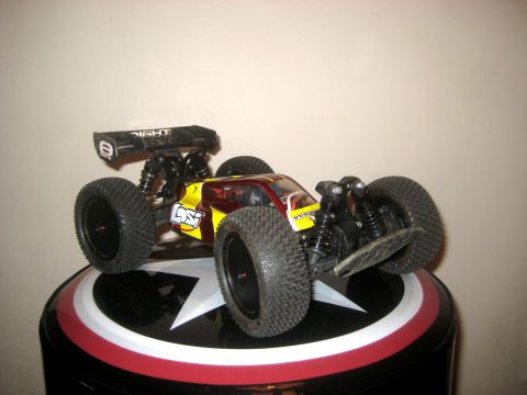 1996 Ford Bronco - A radio-controlled buggy with a spoiler sits on a decorative surface.