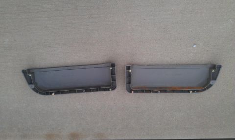 1991 Ford Festiva - Two gray plastic car door panels are shown laid out on a concrete surface.