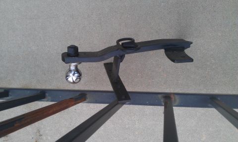 1991 Ford Festiva - A trailer hitch ball mount with a chrome ball is shown against a concrete background.