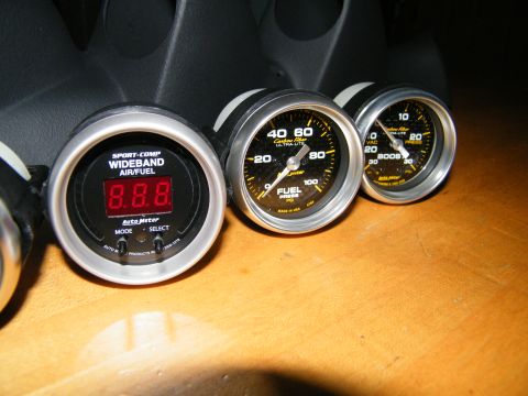 2004 Ford Crown Victoria - Three Auto Meter gauges, including Wideband Air/Fuel, Fuel Pressure, and Boost, are visible in this interior shot.