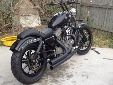 1995 Ford Bronco - A custom Harley-Davidson Sportster sits outside with a yellow oil drain pan nearby.