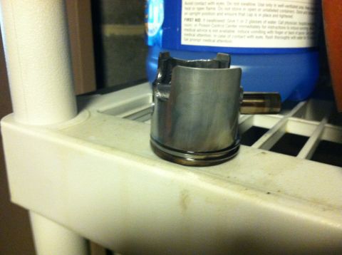 1981 Garelli Rally Sport - A single piston, likely for an engine rebuild, is shown on a shelf next to a blue container.