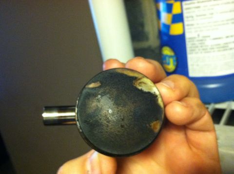 1981 Garelli Rally Sport - A piston, likely from an engine rebuild, shows significant carbon deposits on its crown.