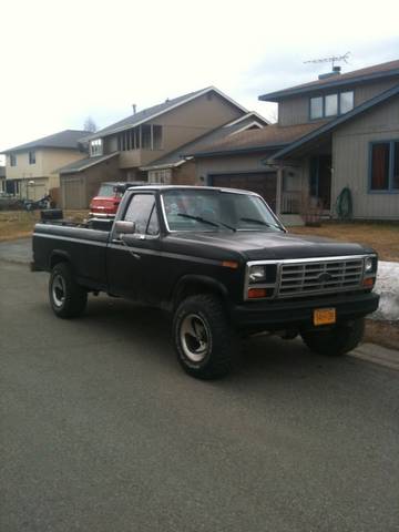 1990 Chevrolet Suburban - This black pickup truck features a grille characteristic of the early 1980s.