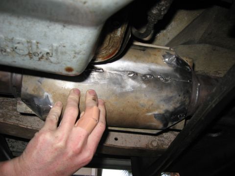 1994 Ford Bronco - Close-up view of a welded exhaust pipe, with a hand present for scale.