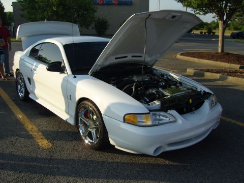 2007 Ford Mustang - A white 1994 Ford Mustang is parked with its hood open, revealing the engine compartment.