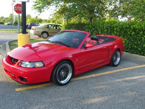 2007 Ford Mustang - Red 2007 Ford Mustang convertible with black interior and aftermarket wheels.