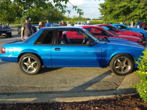 2007 Ford Mustang - A blue coupe is parked in a lot with other cars visible in the background.