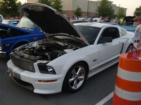 2007 Ford Mustang - A white 2007 Ford Mustang GT is displayed with its hood open at a car meet.