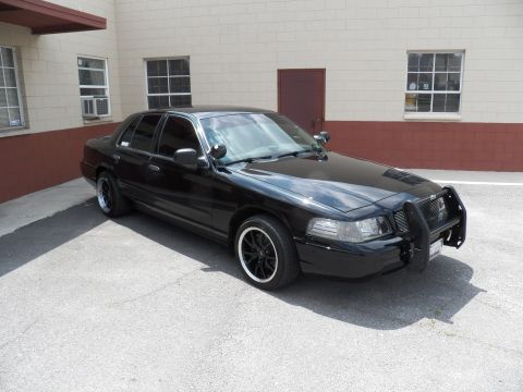 2003 Ford Crown Victoria - Front three-quarter of a blacked-out Ford Crown Victoria sedan fitted with a front push bar.