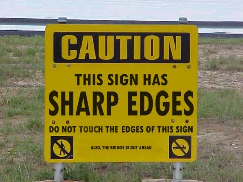 2001 Ford Taurus - A caution sign warns of sharp edges and that the bridge is out ahead.
