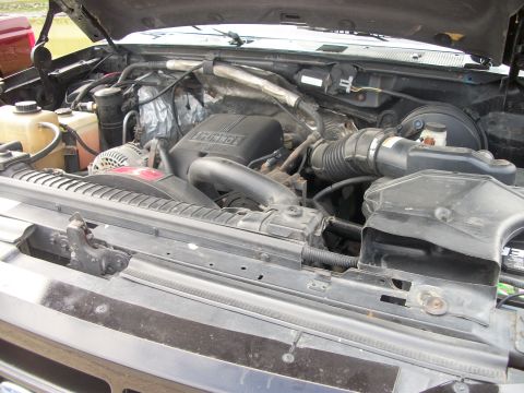 1996 Ford Bronco - The engine compartment of a vehicle is shown with various components and wiring.