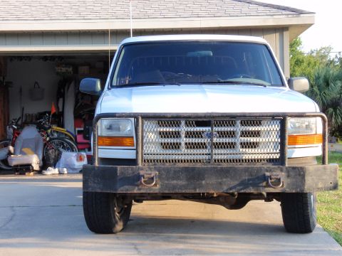 1995 Ford Bronco - Front view of a white 1995 Ford Bronco, equipped with a heavy-duty brush guard and bumper.