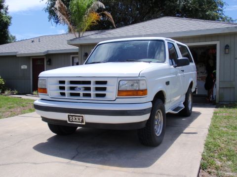 1995 Ford Bronco - This white 1995 Ford Bronco is parked in a driveway with a "BEEF" license plate.