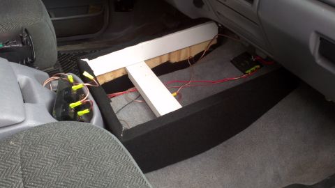 1995 Ford Bronco - The center console area of a vehicle shows exposed wiring and a custom wooden support structure.