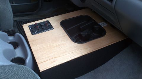 1995 Ford Bronco - Interior view of a custom wooden center console with toggle switches and cup holders.