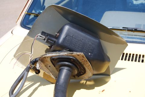 1975 Ford Ranchero - Close-up of an interior automotive part with visible wiring and a black plastic housing containing text.