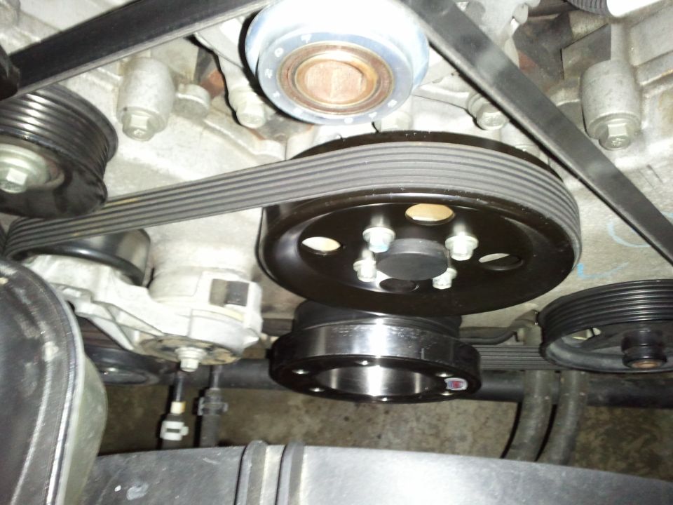Close-up of engine belt pulleys and serpentine belt