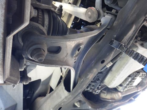 2003 Ford Taurus - Underside view of automotive suspension parts, likely front lower control arms and ball joints.