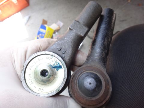 2003 Ford Taurus - Comparison of a new "Problem Solver" tie rod end with a used one, likely for a vehicle repair.