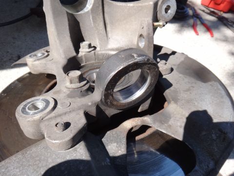 2003 Ford Taurus - Close-up of a worn wheel hub assembly part with a bearing race, likely needing replacement.