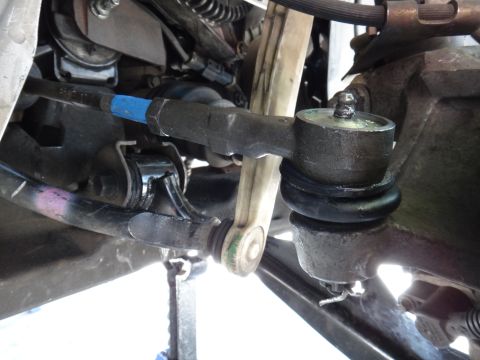 2003 Ford Taurus - This is a close-up view of a vehicle's steering and suspension components, specifically the tie rod end.