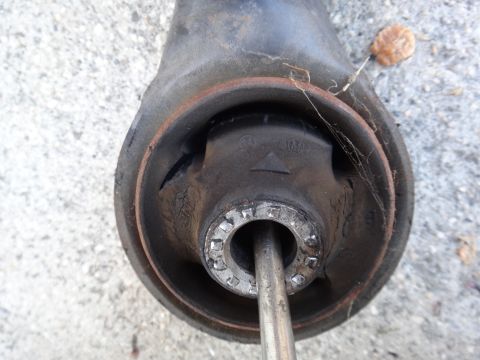 2003 Ford Taurus - This is a close-up view of a worn suspension part, showing signs of damage and rust.