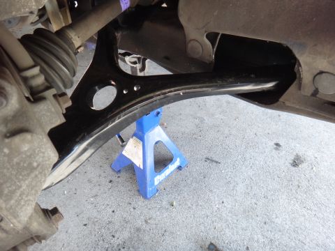 2003 Ford Taurus - Close-up of a vehicle's suspension system, focusing on the lower control arm and ball joint assembly.