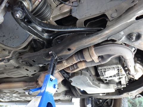 2003 Ford Taurus - Underside view of the front lower control arm and ball joint assembly on a 2003 Ford Taurus.