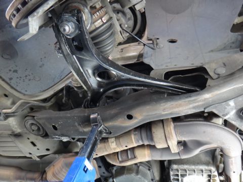 2003 Ford Taurus - Underside view of a vehicle's front suspension system, focusing on the control arm and ball joint.