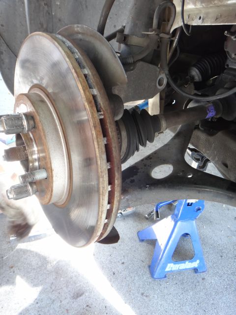 2003 Ford Taurus - Front suspension and brake assembly, likely undergoing maintenance or repair.