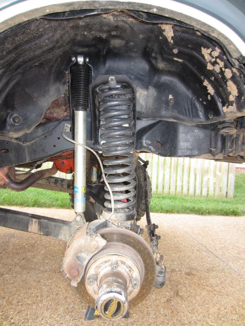 1992 Ford Bronco - Close-up view of the front suspension and wheel hub of a 1992 Ford Bronco.