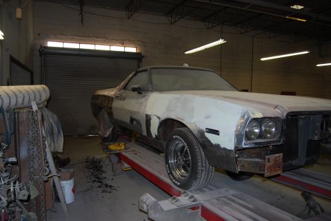 1975 Ford Ranchero - This 1975 Ford Ranchero is in a garage, possibly undergoing repairs or restoration, with its front end showing body filler.