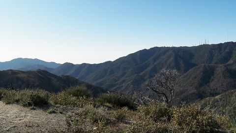 2003 Ford Crown Victoria - View across forested mountain ridges with communication towers on a distant peak