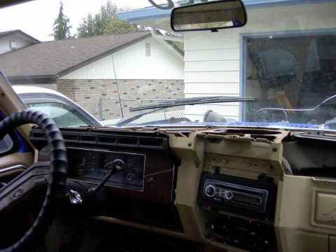 1980 Ford Bronco - The interior dashboard of a 1980 Ford Bronco shows wood grain trim and an aftermarket radio, suggesting it is from the early 1980s.