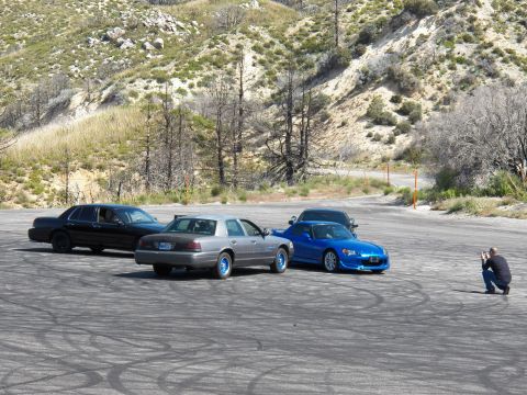 2003 Ford Crown Victoria - Three vehicles in a row on a mountain pullout with a kneeling photographer