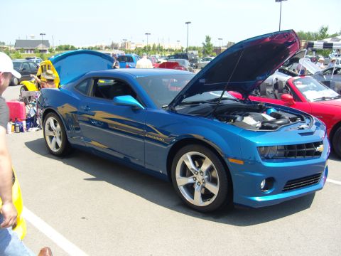 2007 Ford Mustang - A blue Chevrolet Camaro is displayed with its hood open at a car show.