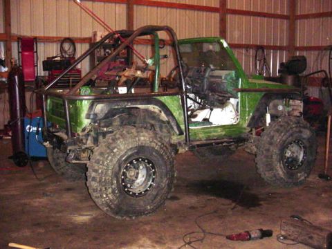 1992 Ford Bronco - Modified off-road vehicle undergoing customization in a workshop.