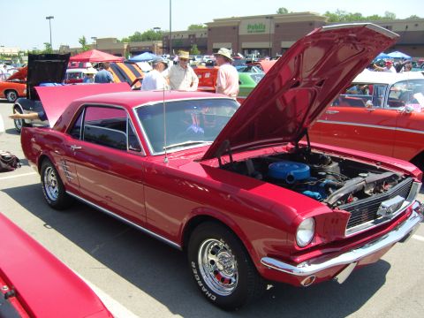 2007 Ford Mustang - A red 1965 Ford Mustang coupe is displayed with its hood open at a car show.