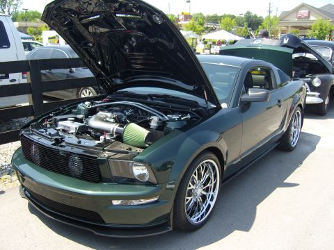 2007 Ford Mustang - 2007 Ford Mustang on display with hood open, revealing the engine bay and custom modifications.