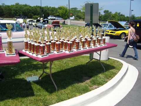 2007 Ford Mustang - Outdoor event with tables full of trophies and cars parked in the background.