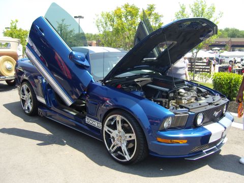 2007 Ford Mustang - Customized 2007 Ford Mustang GT500 with gullwing doors and exposed engine at a car show.