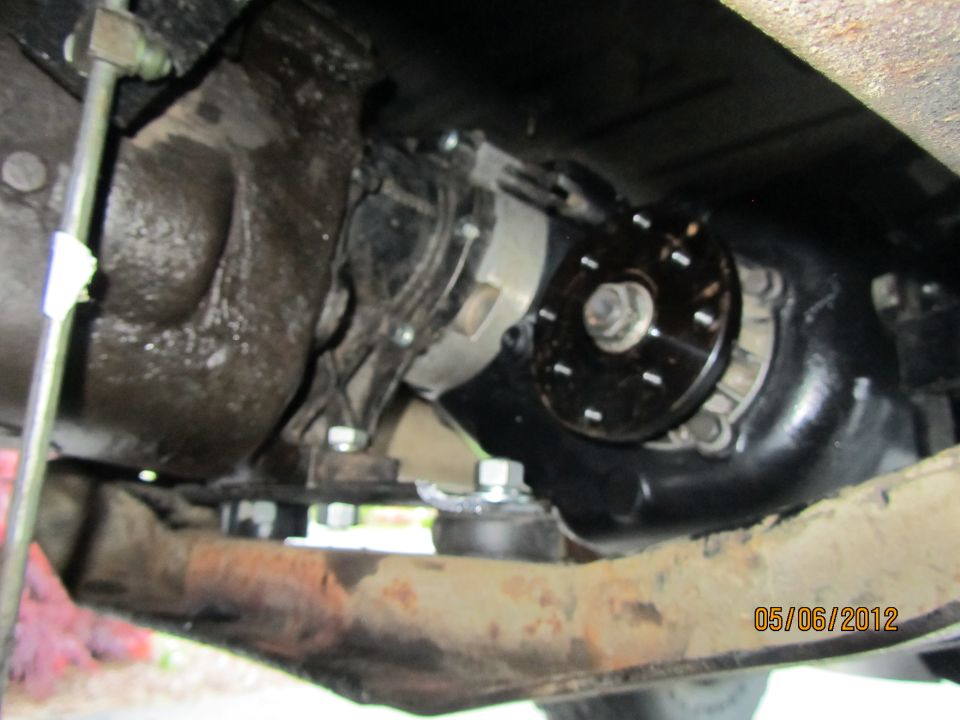 Underside view of vehicle drivetrain showing transfer case and related parts. Date stamp 05/06/2012