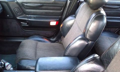 1991 Ford Taurus - Interior view of a 1991 Ford Taurus, showing the driver's seat and door panel details.
