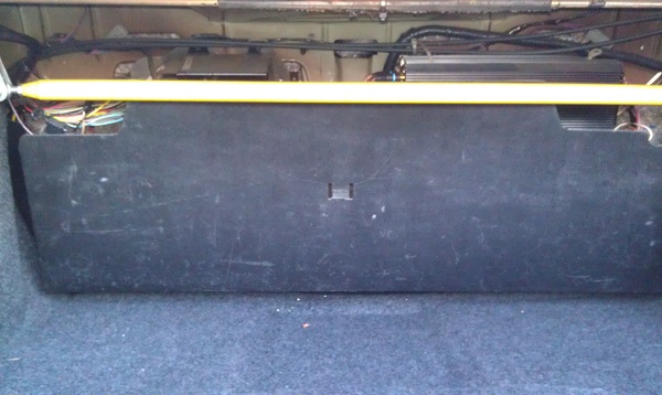 Trunk interior with amplifier and yellow strut bar